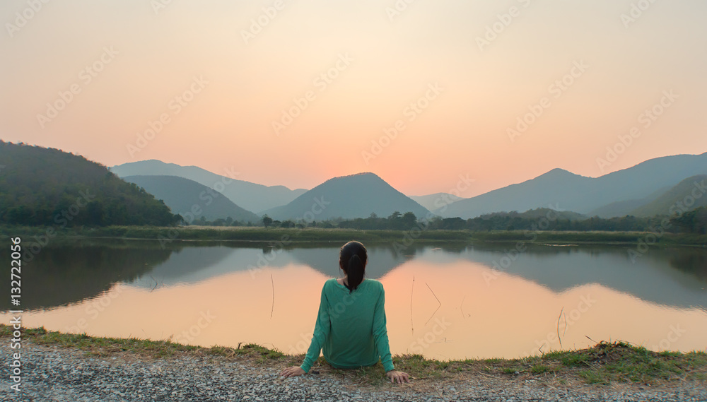 An Asian woman social distancing in sunset by the lake - obrazy, fototapety, plakaty 