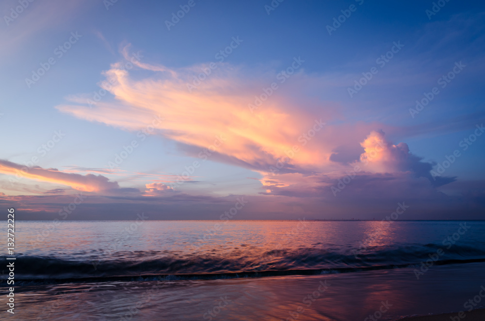 Beautiful beach light at dawn with dramatic sky