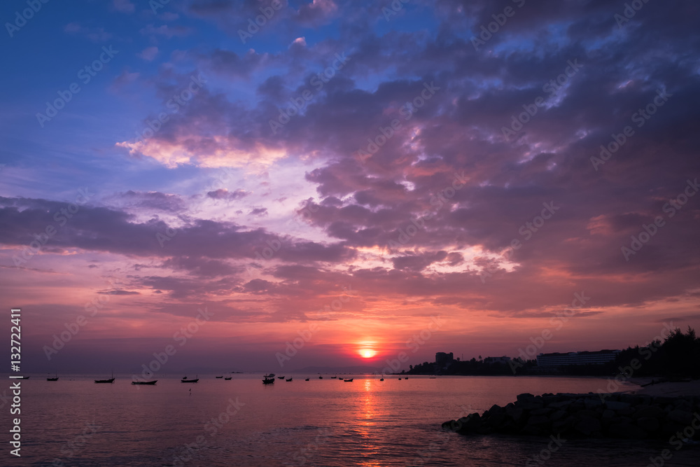 Sunset on the beach with fisherman boat