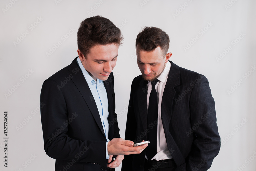 Young businessmen with the smartphone on a white background Young businessmen with the smartphone on a white background