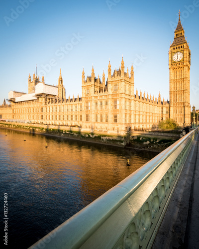 Big Ben and the Palace of Westminster. Low angle view of the famous clock tower London landmark in the early morning sun.