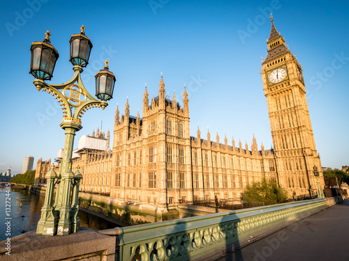 Big Ben and the Palace of Westminster. Low angle view of the famous clock tower London landmark in the early morning sun.