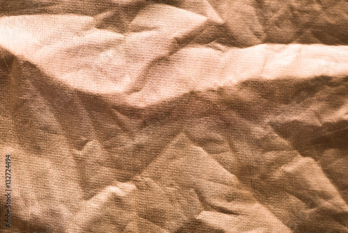 Crumpled gold paper with breaks and irregularities. Golden abstract  background 