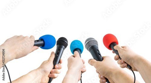 Journalism and conference concept. Many reporter hands hold microphones. Isolated on white background.