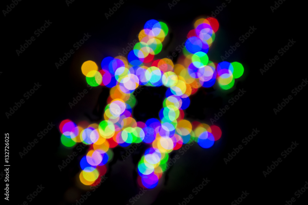 Abstract bokeh lights forming hashtag on black background