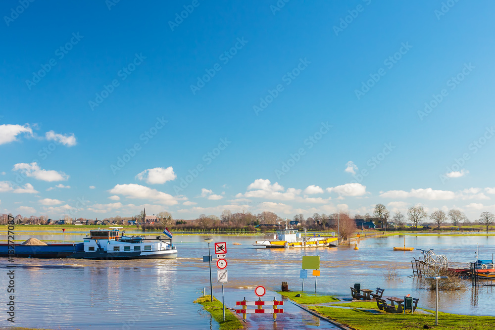 Flooded road in front of the Dutch river IJssel