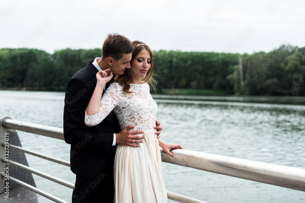 happy bride and groom at a park on their wedding day happy bride and groom at a park on their wedding day