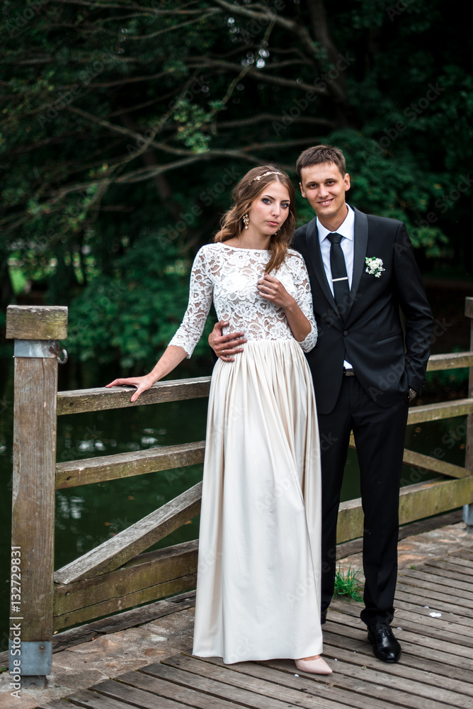 happy bride and groom at a park on their wedding day happy bride and groom at a park on their wedding day