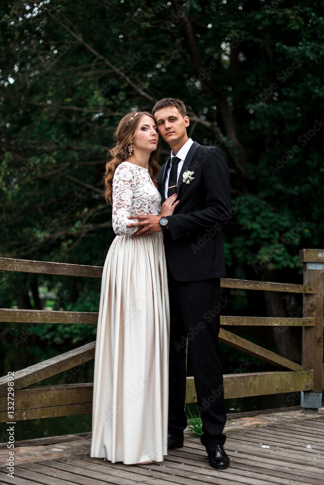 happy bride and groom at a park on their wedding day happy bride and groom at a park on their wedding day