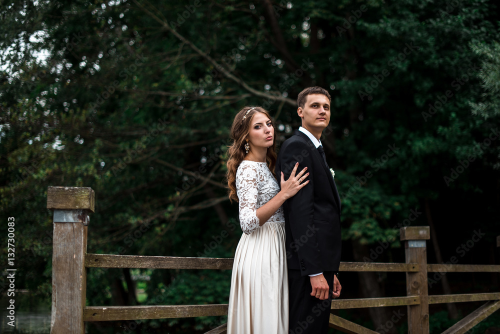 happy bride and groom at a park on their wedding day happy bride and groom at a park on their wedding day