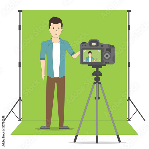 Studio blog recording on chroma key background. Vlog. Video recording. Handsome boystanding and recording himself. Social sites.