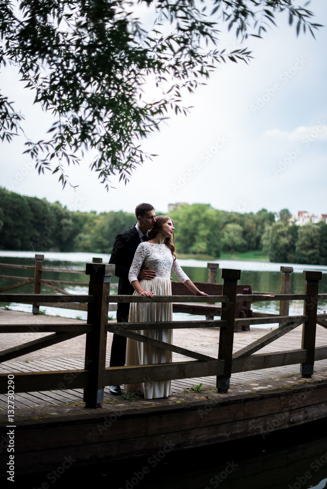 happy bride and groom at a park on their wedding day happy bride and groom at a park on their wedding day