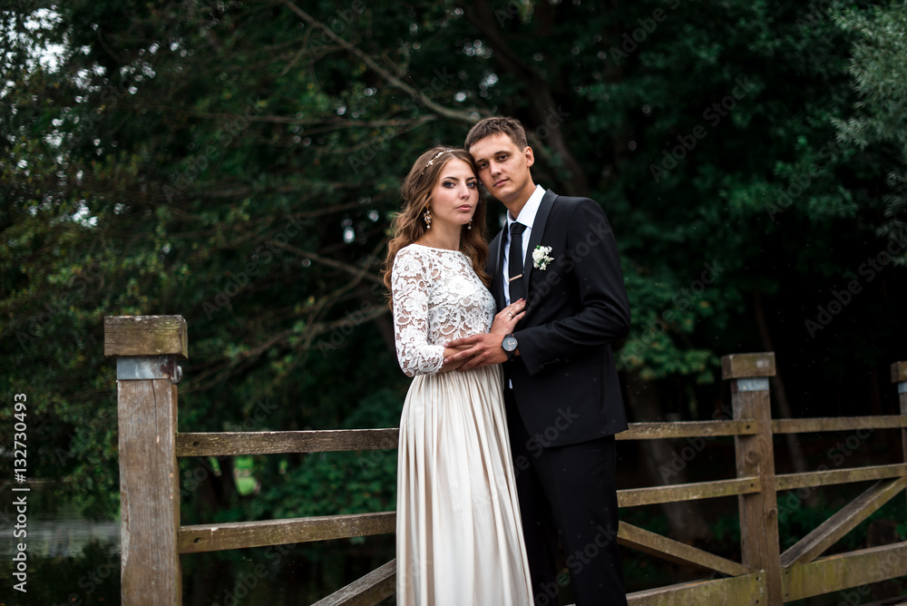 happy bride and groom at a park on their wedding day happy bride and groom at a park on their wedding day