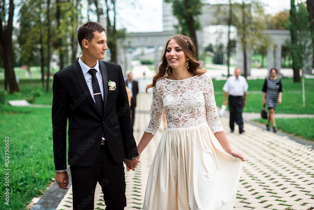 happy bride and groom at a park on their wedding day happy bride and groom at a park on their wedding day