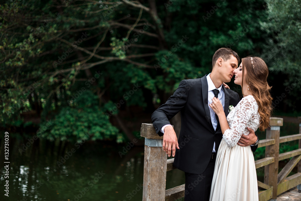 happy bride and groom at a park on their wedding day happy bride and groom at a park on their wedding day