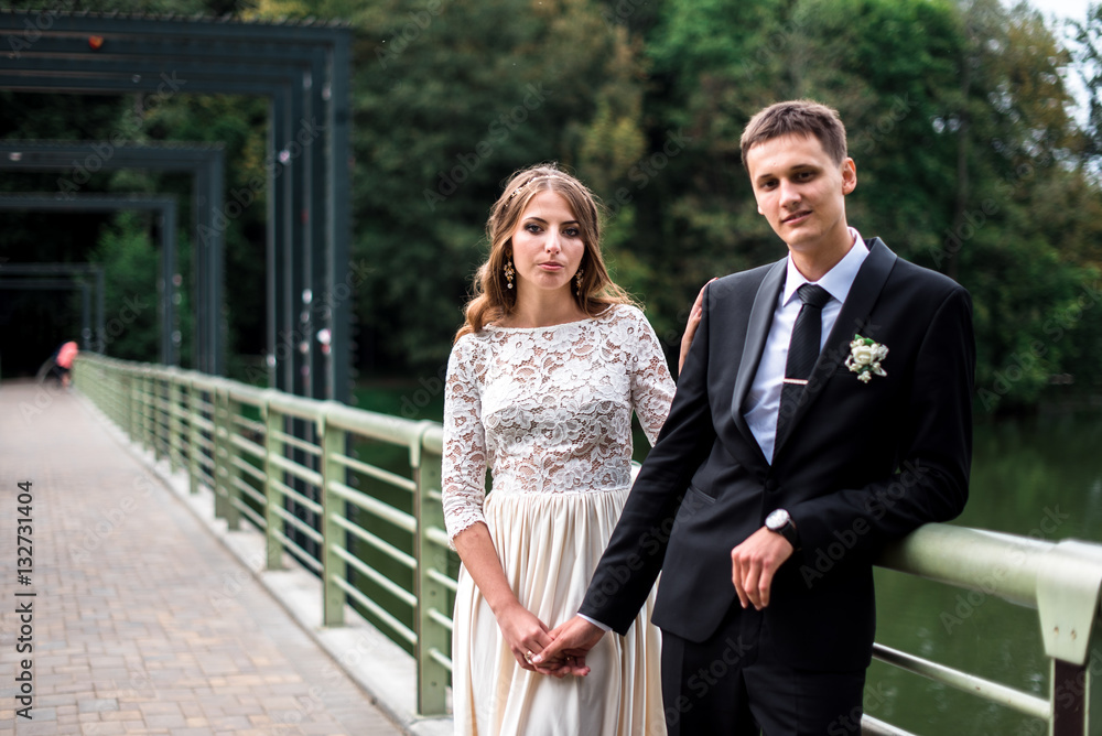 happy bride and groom at a park on their wedding day happy bride and groom at a park on their wedding day