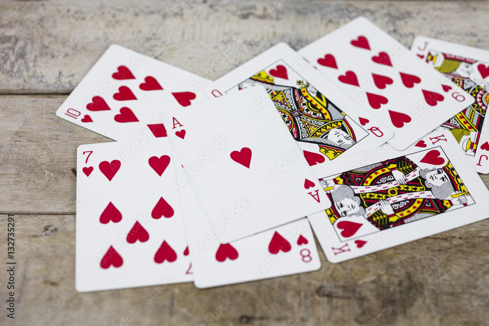 Detail of heart deck poker playing cars on wooden table Detail of heart deck poker playing cars on wooden table