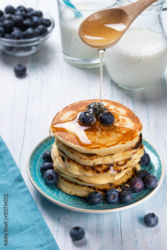 Stack of pancakes with fresh blueberry and honey, healthy breakfast concept