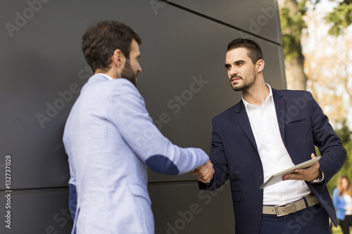 Young businessmen handshaki...