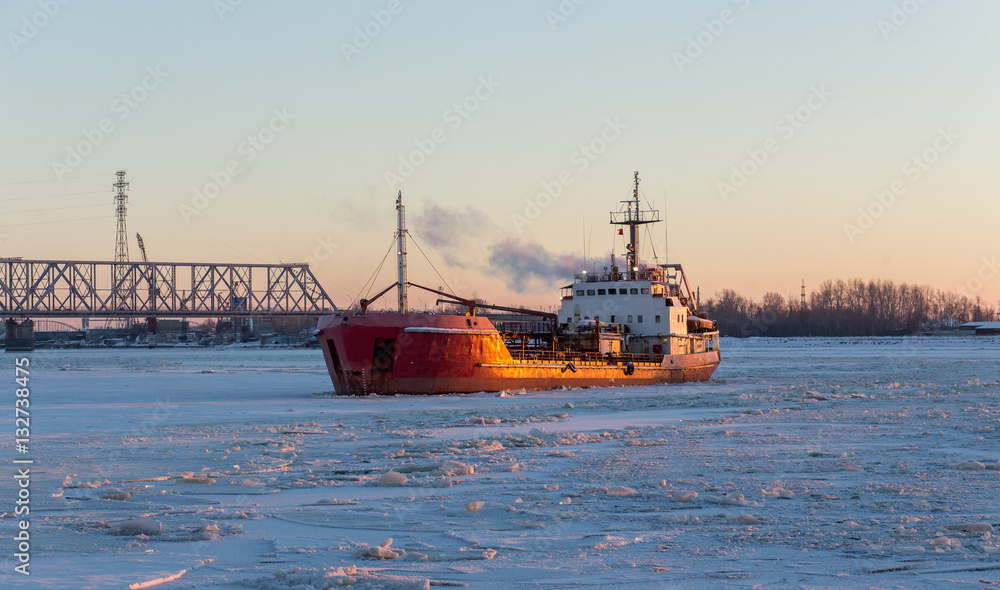 Ship tanker in the river ice. Frosty day Ship tanker in the river ice. Frosty day