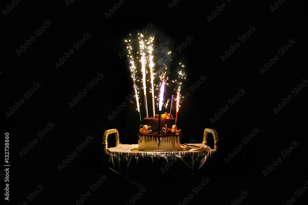 Birthday cake with fireworks on table in black background Stock Photo |  Adobe Stock