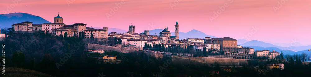 Poster, Foto Bergamo Alta old town colored af sunset's lights - Lombardy  Italy - Koop op EuroPosters.nl