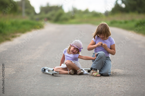 girl scooter fell In the countryside, sister helps her child