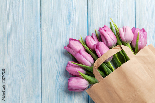 Fototapeta Naklejka Na Ścianę i Meble -  Fresh pink tulip flowers in paper bag