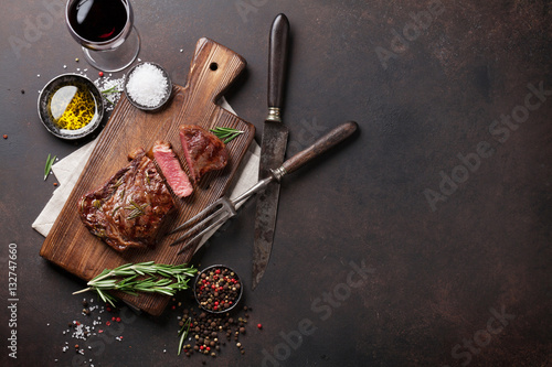 Grilled ribeye beef steak with red wine, herbs and spices