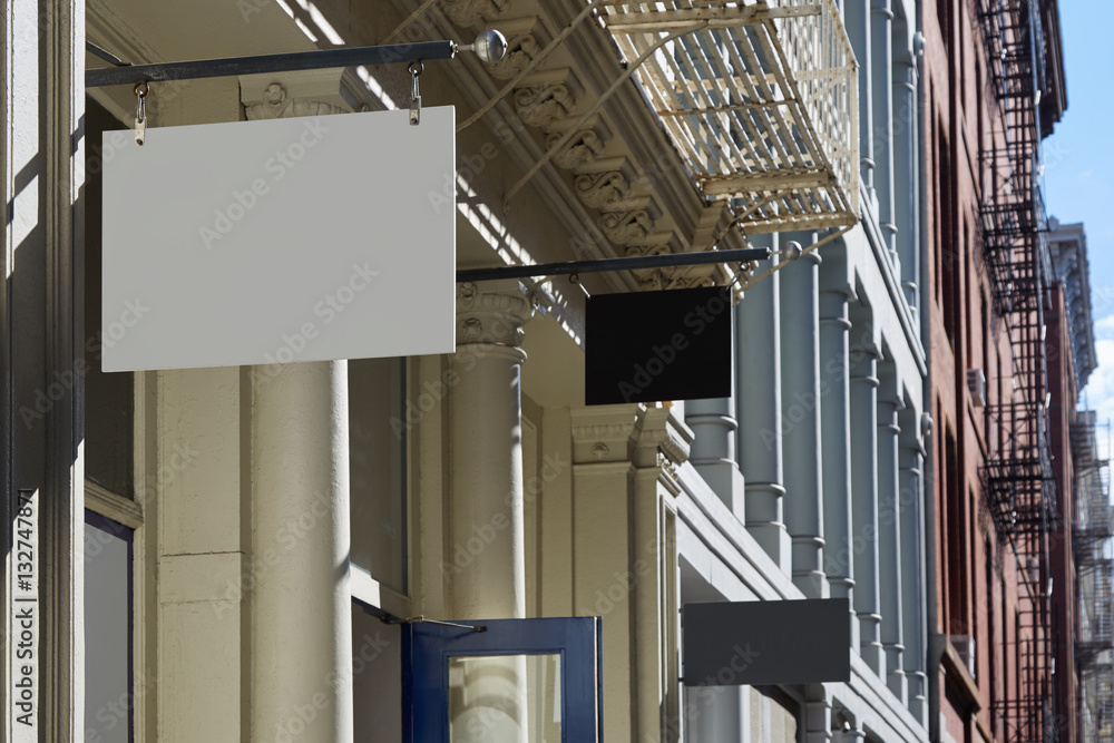Buildings with blank store signs in a sunny day in New York Buildings with blank store signs in a sunny day in New York