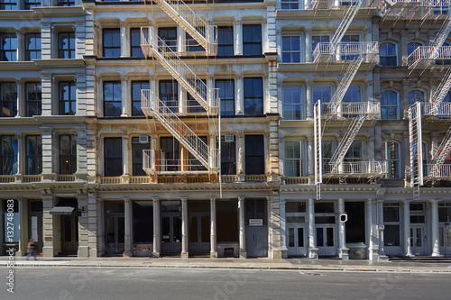 New York building facades with fire escape stairs and empty street