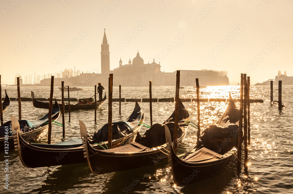 Retro effect filtered hipster style image of Gondolas on Grand canal in Venice, Italy. Beautiful summer landscape at sunset.