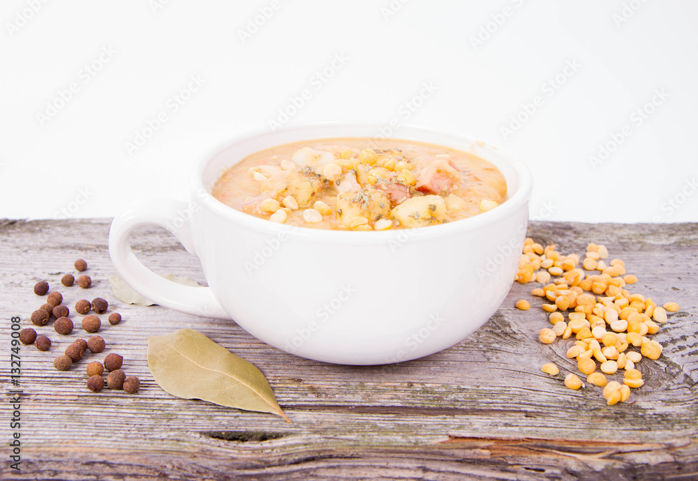 Split pea soup, decorated with some bay leaves, marjoram and peas Split pea soup, decorated with some bay leaves, marjoram and peas