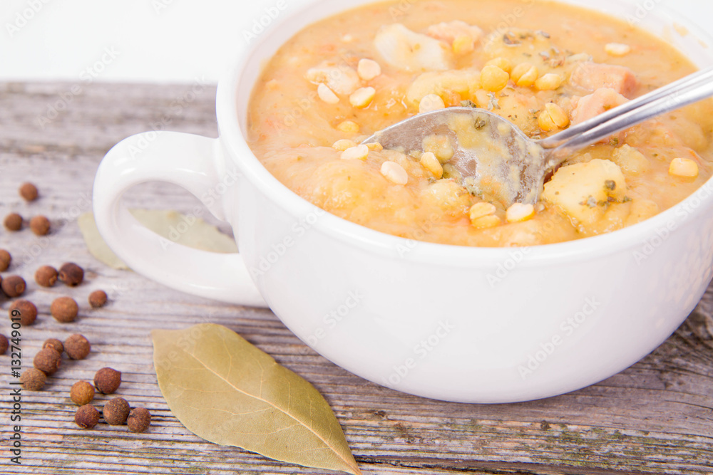 Split pea soup, decorated with some bay leaves, marjoram and peas Split pea soup, decorated with some bay leaves, marjoram and peas