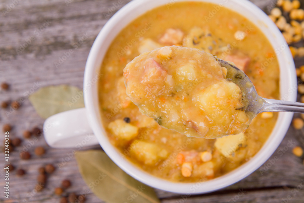 Split pea soup, decorated with some bay leaves, marjoram and peas Split pea soup, decorated with some bay leaves, marjoram and peas