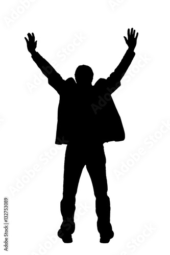 Silhouette of man with hands raised