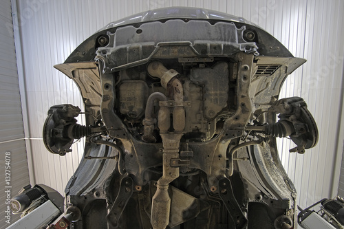 underside view of a car in a car repair station underside view