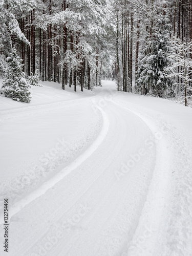 car tire tracks on winter road
