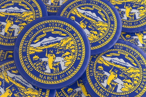 US State Buttons: Pile of Nebraska Flag Badges, 3d illustration © cbies