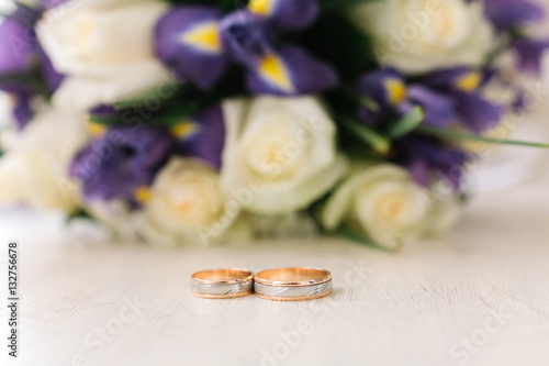 gold rings against the background of a wedding bouquet