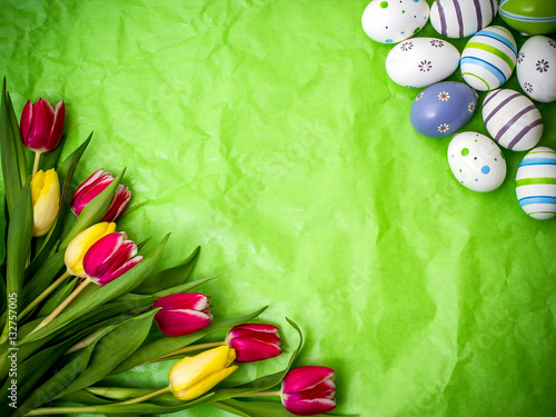 Eastern egg, tulips on green crumpled wrapping paper