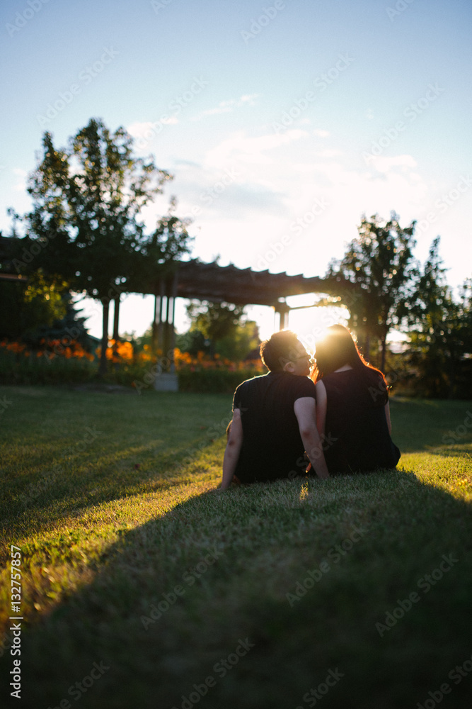 couple kissing on grass