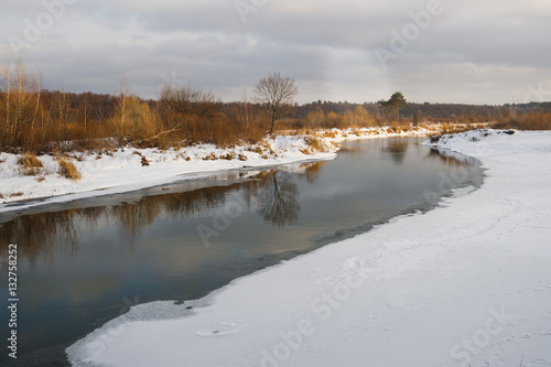non-freezing river on winter forest backgrounds