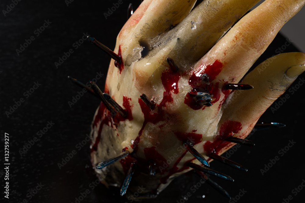 wax hand sculpture with nails and blood