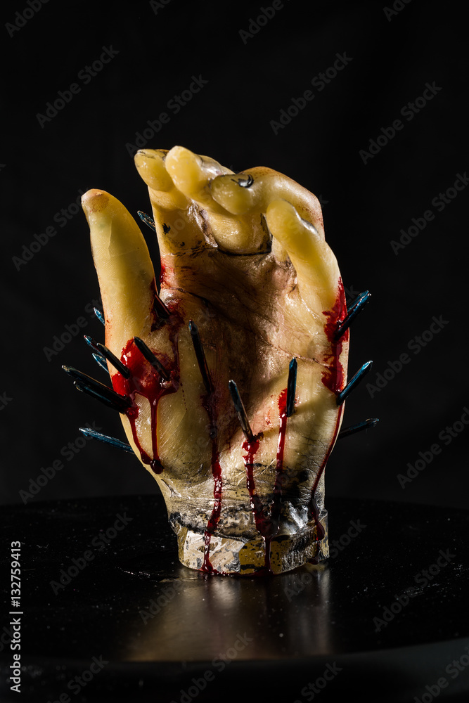 wax hand sculpture with nails and blood