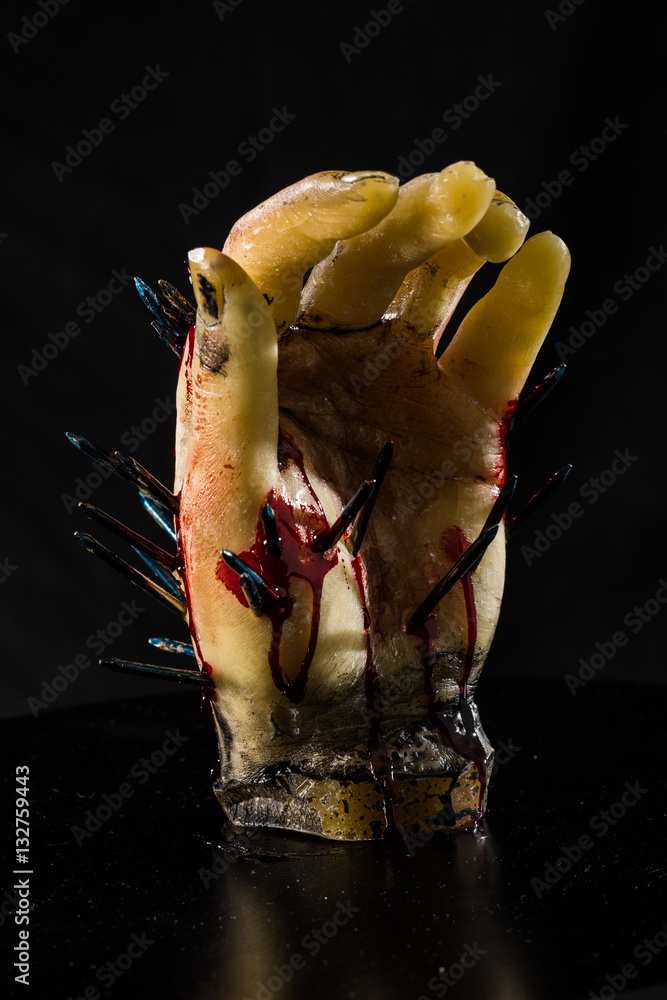wax hand sculpture with nails and blood
