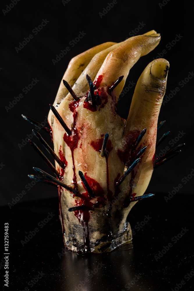 wax hand sculpture with nails and blood