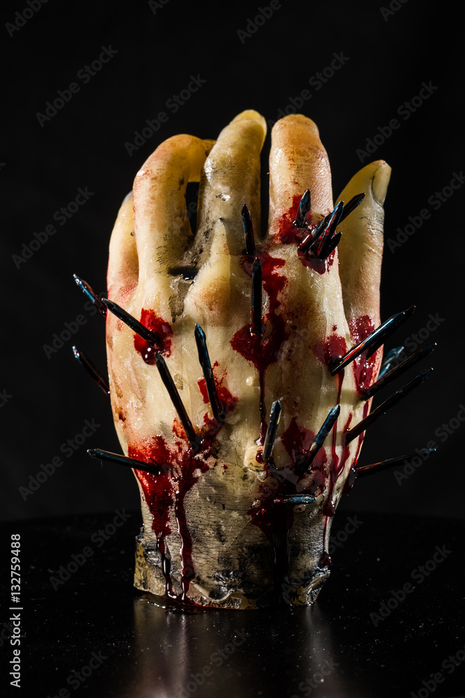 wax hand sculpture with nails and blood