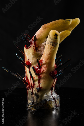 wax hand sculpture with nails and blood