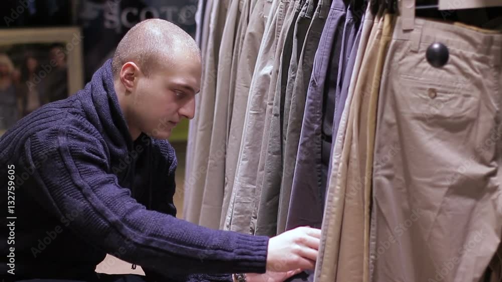 Young Man Shopping for Jeans in Store. Close up Young Man Shopping for Jeans in Store. Close up